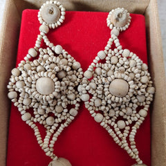 Decorative earrings in a box with a red interior